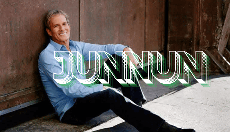 Michael Bolton leaning back while sitting in a stylish and elegant pose