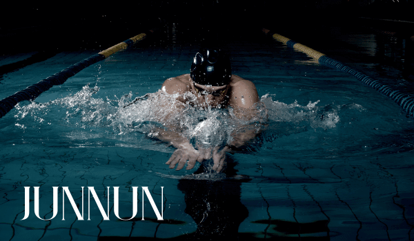 Person swimming gracefully in a clear blue pool